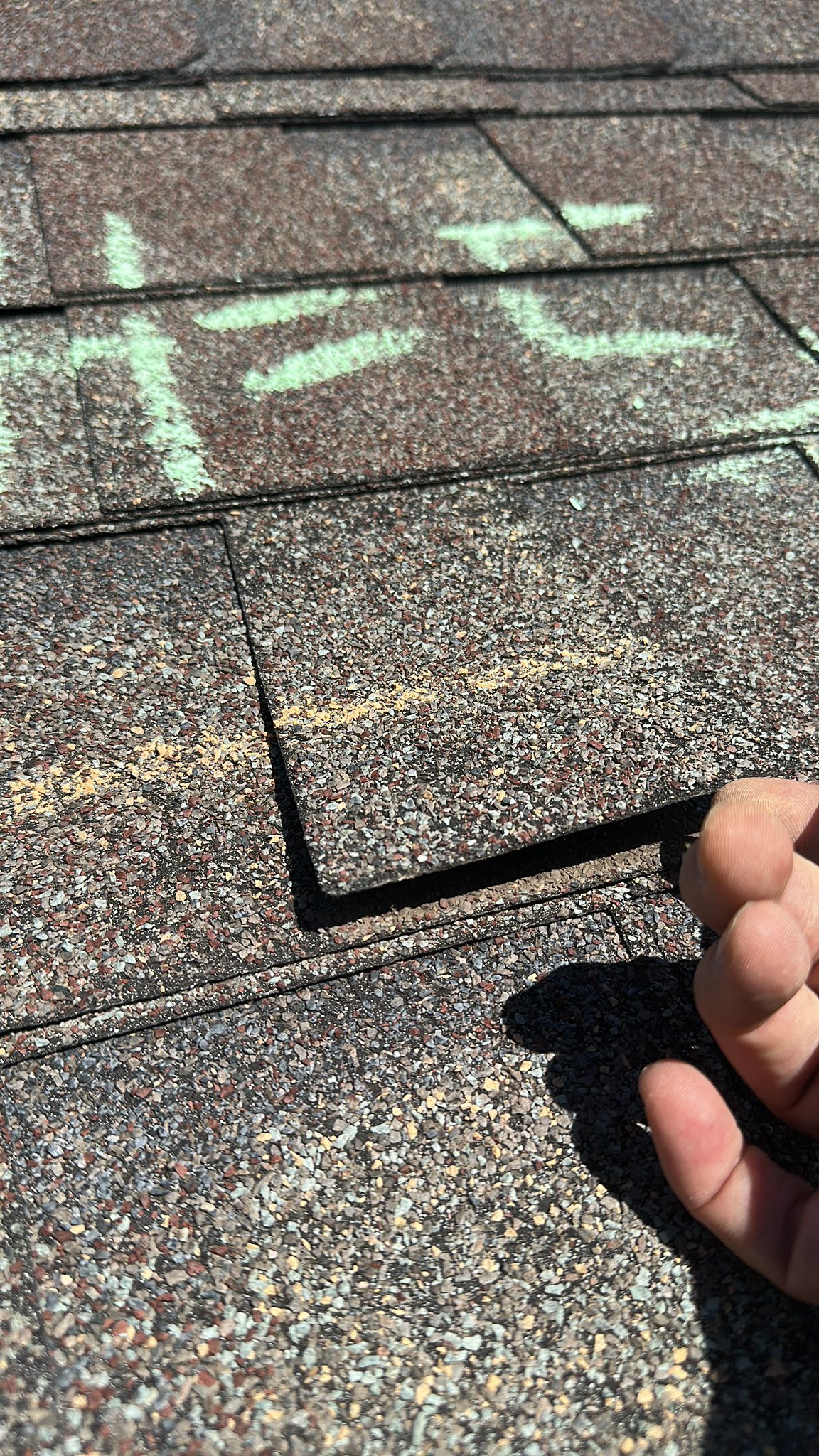 Hail damage chalk marks on shingles